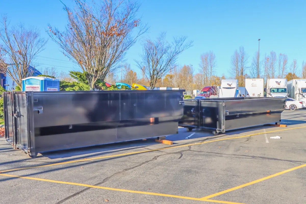 Professional dumpster rental service with roll-off container on residential driveway in Joliet